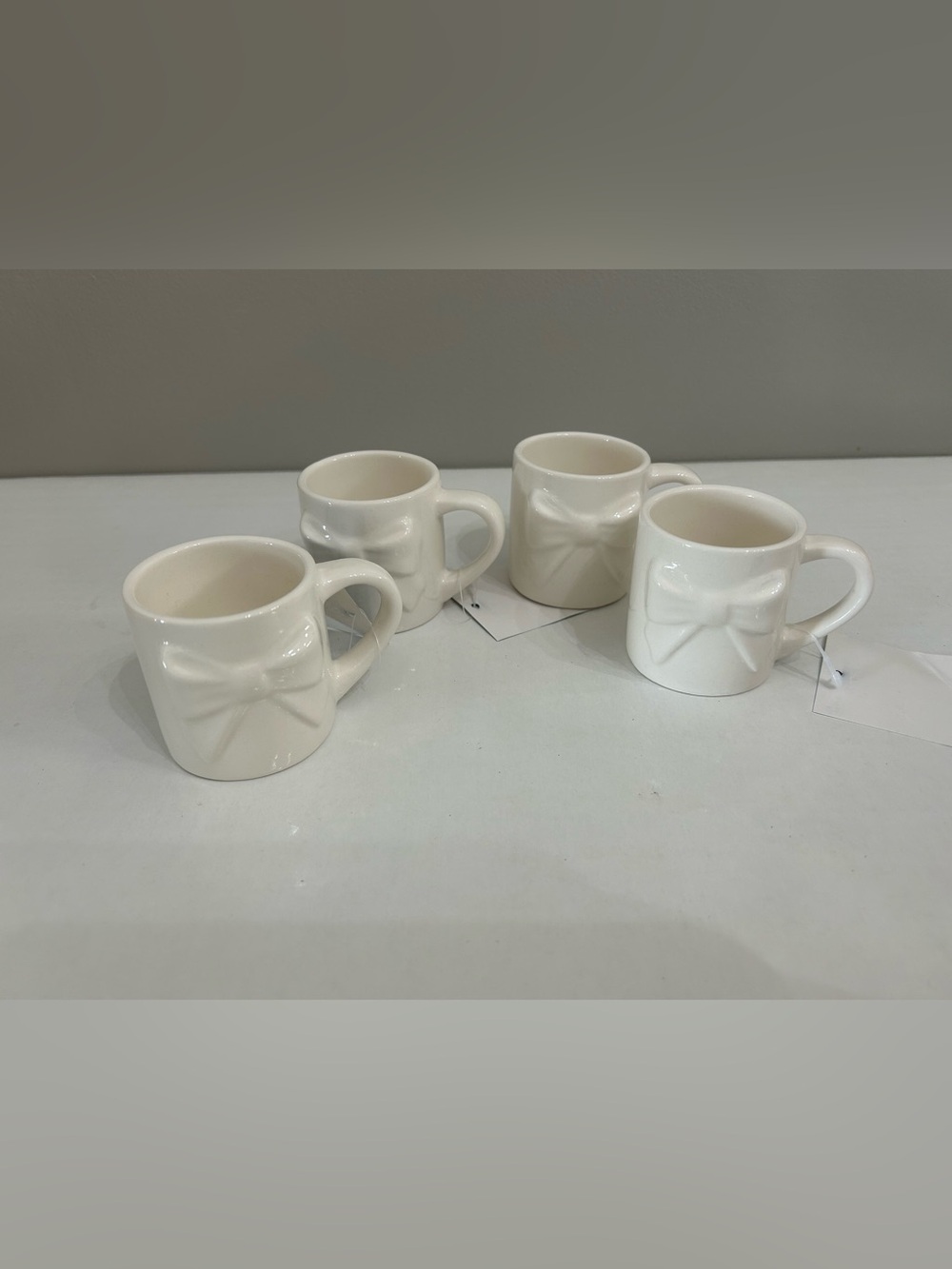 The Spring Shop White Ceramic Mini Mug with Raised Bow Accent - Set of 4